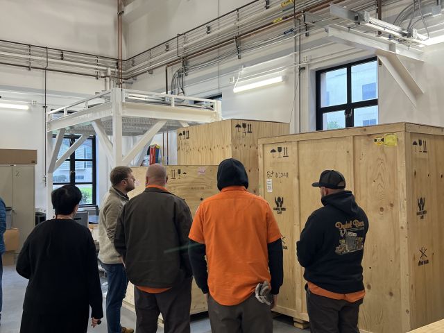 The moving team inspecting the Glacios boxes at their temporary storage in physics