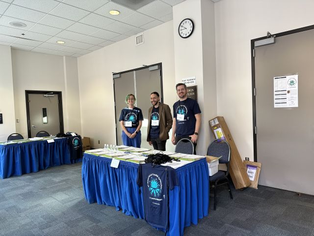 Rowan, Peter, and Pierre manning the check-in booth in matching T-shirts